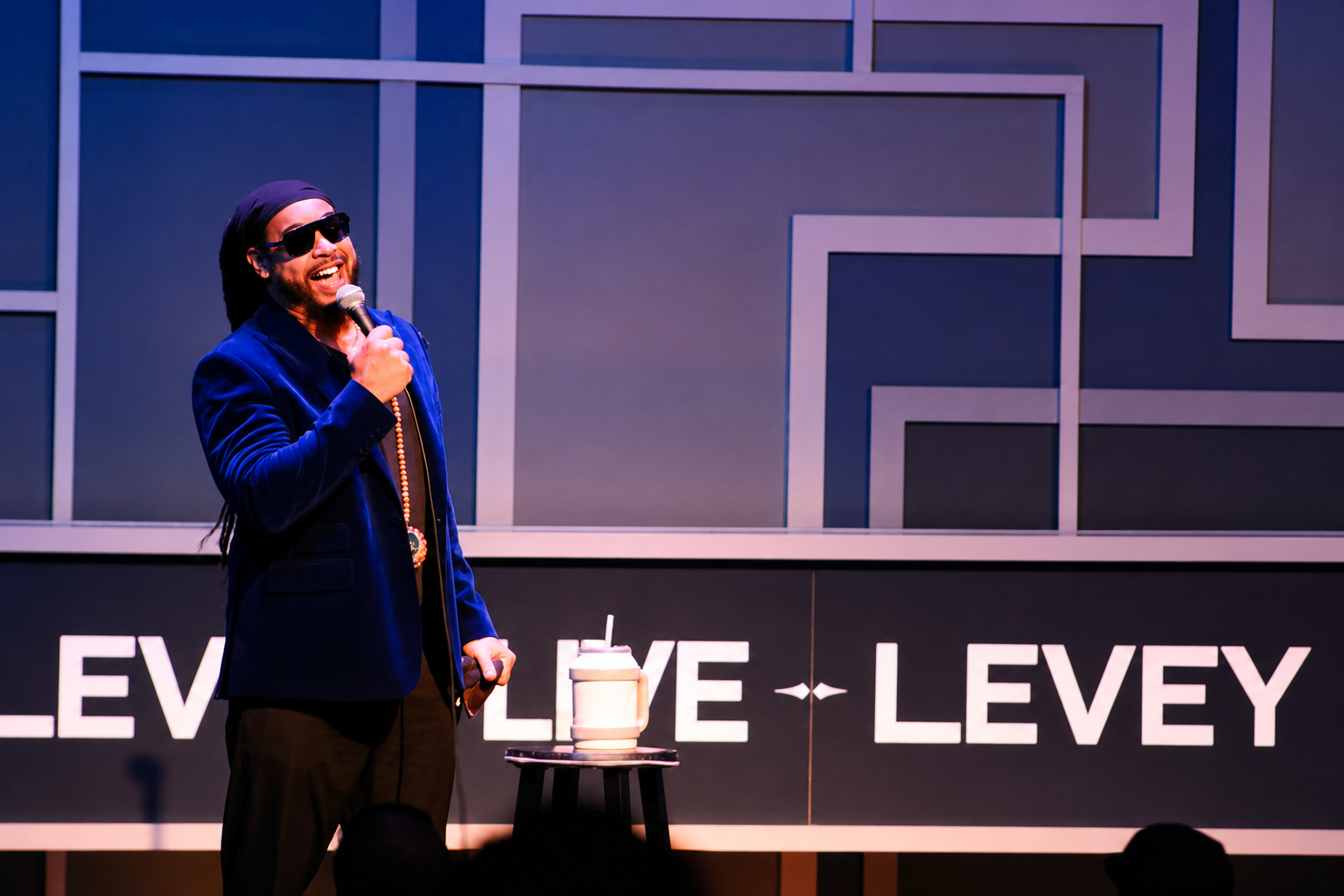 PRECYSE performing live on stage with a microphone